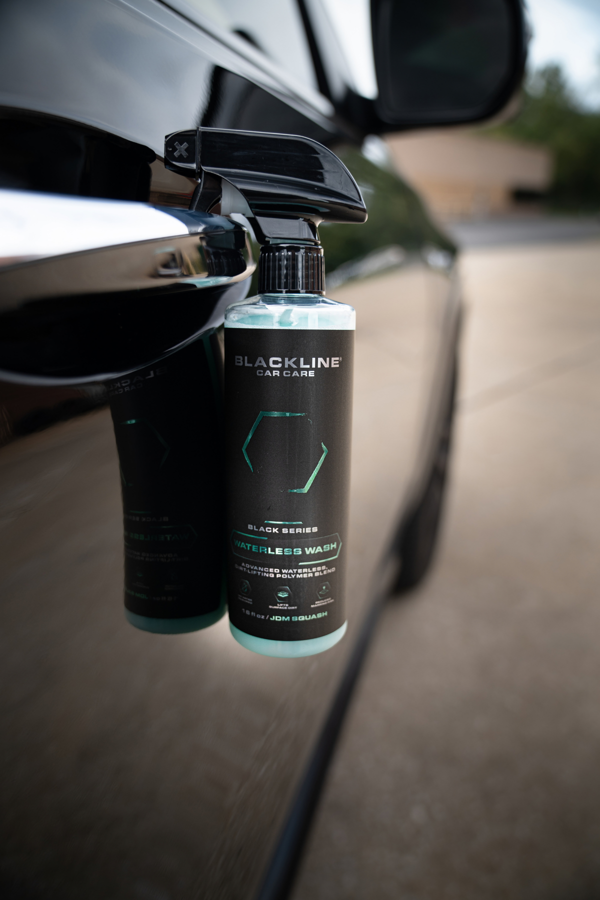 Blackline Waterless Wash spray bottle on dark background, front view of Black Series formula