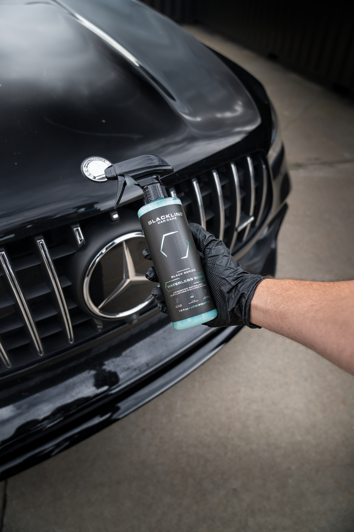 Blackline Waterless Wash bottle alongside a microfiber cloth for spray-and-wipe car cleaning