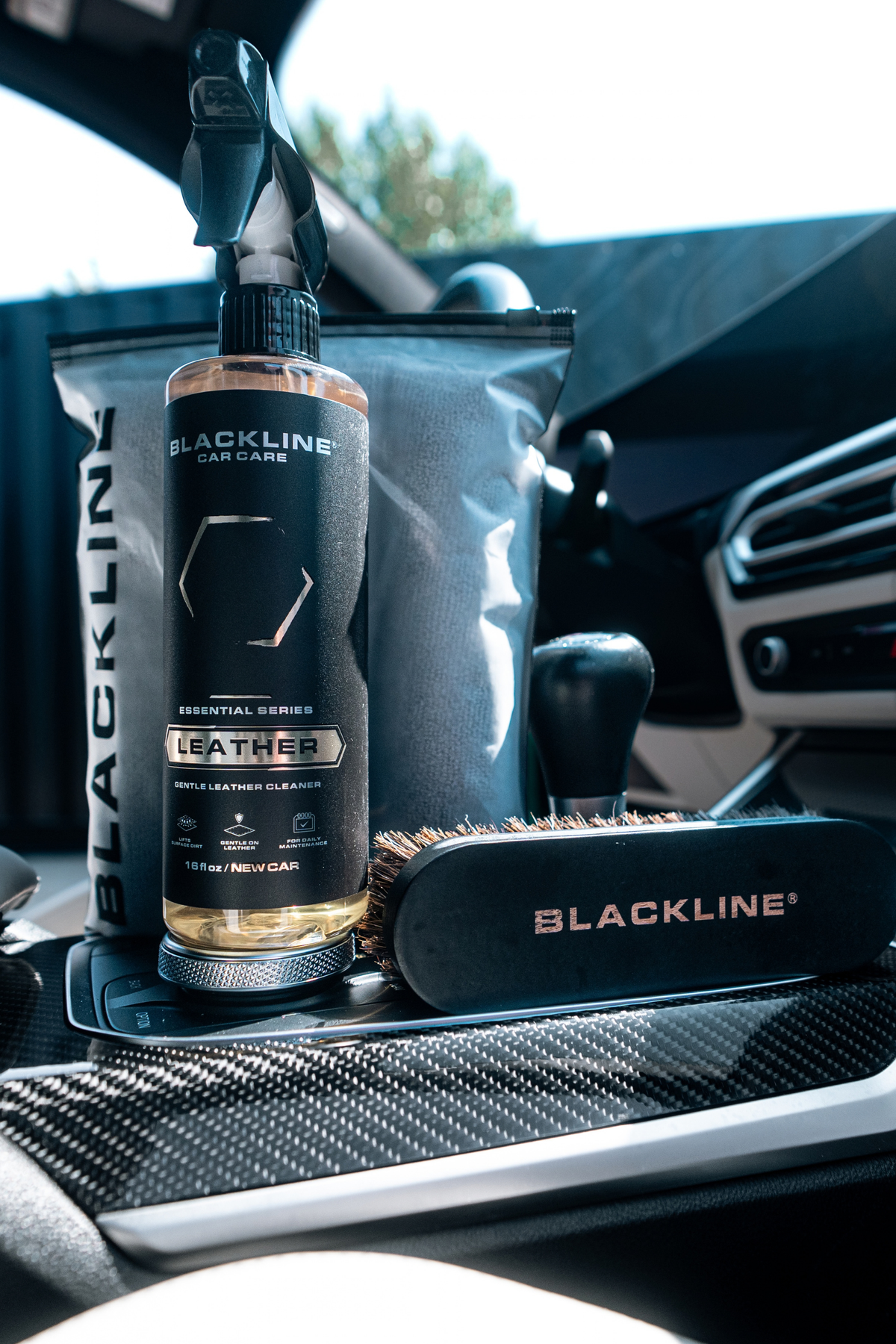 Blackline Leather cleaner applied to a dark perforated leather car seat during interior detailing.
