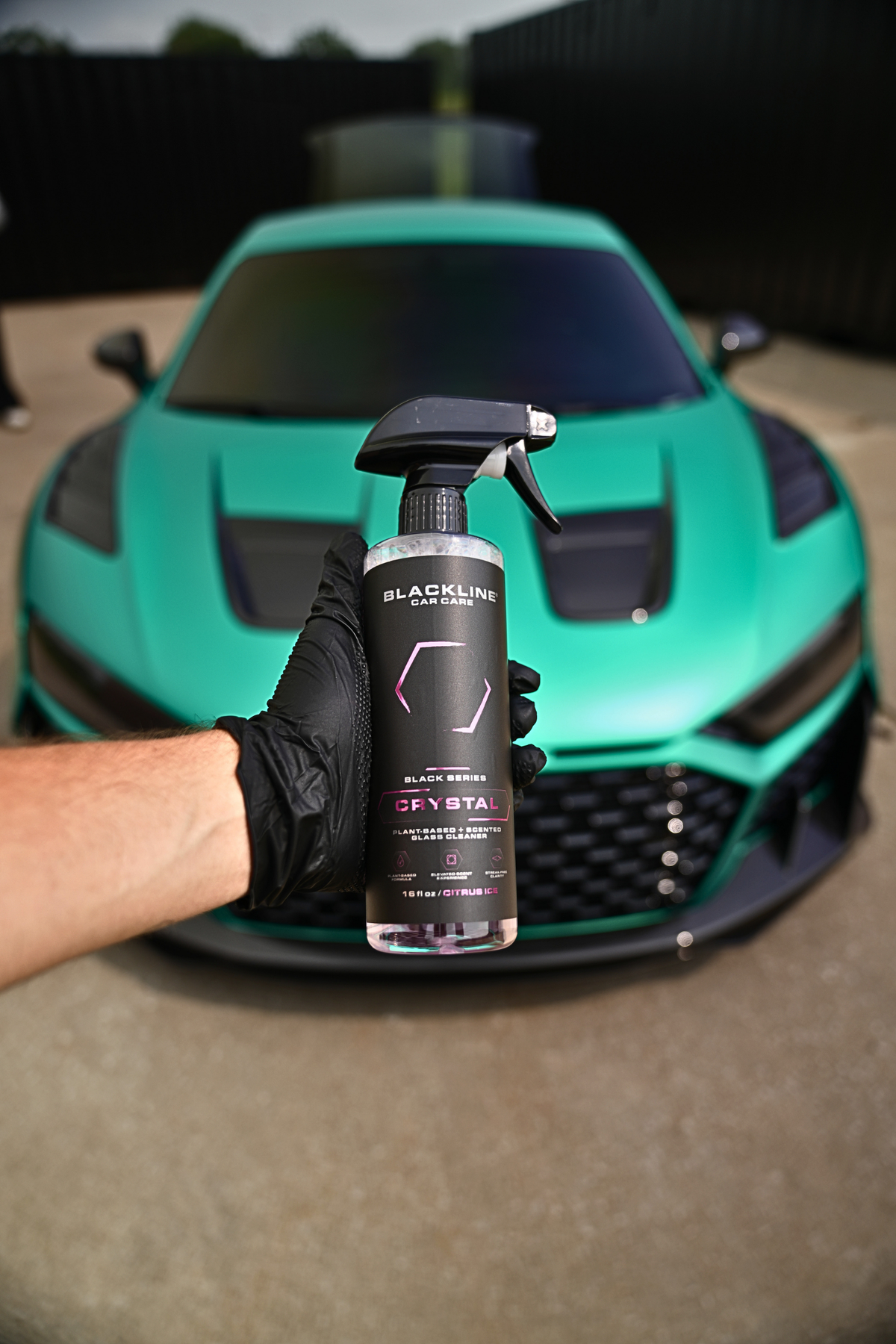 Blackline Crystal Glass Cleaner spray bottle on a dark background