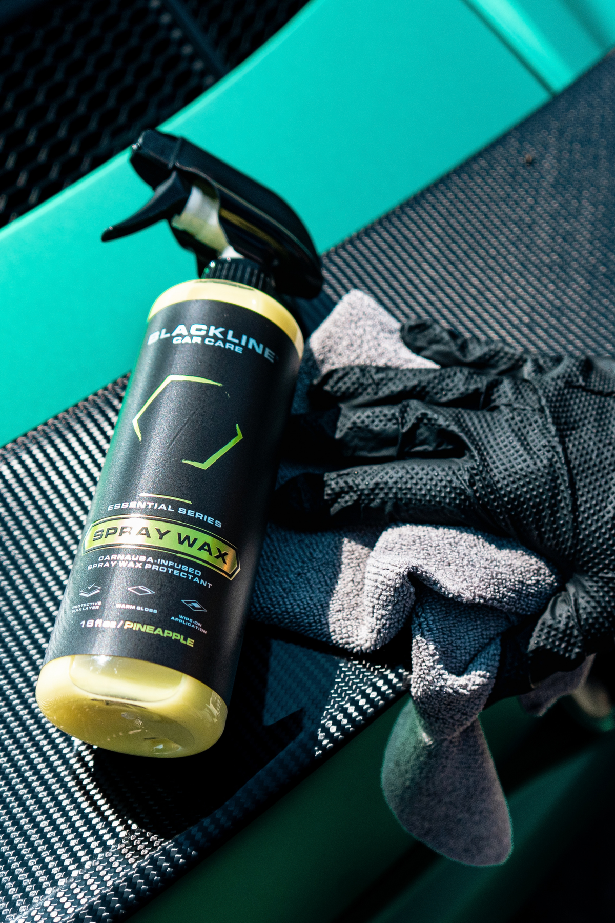 Blackline Essential Series Spray Wax black bottle on dark background.