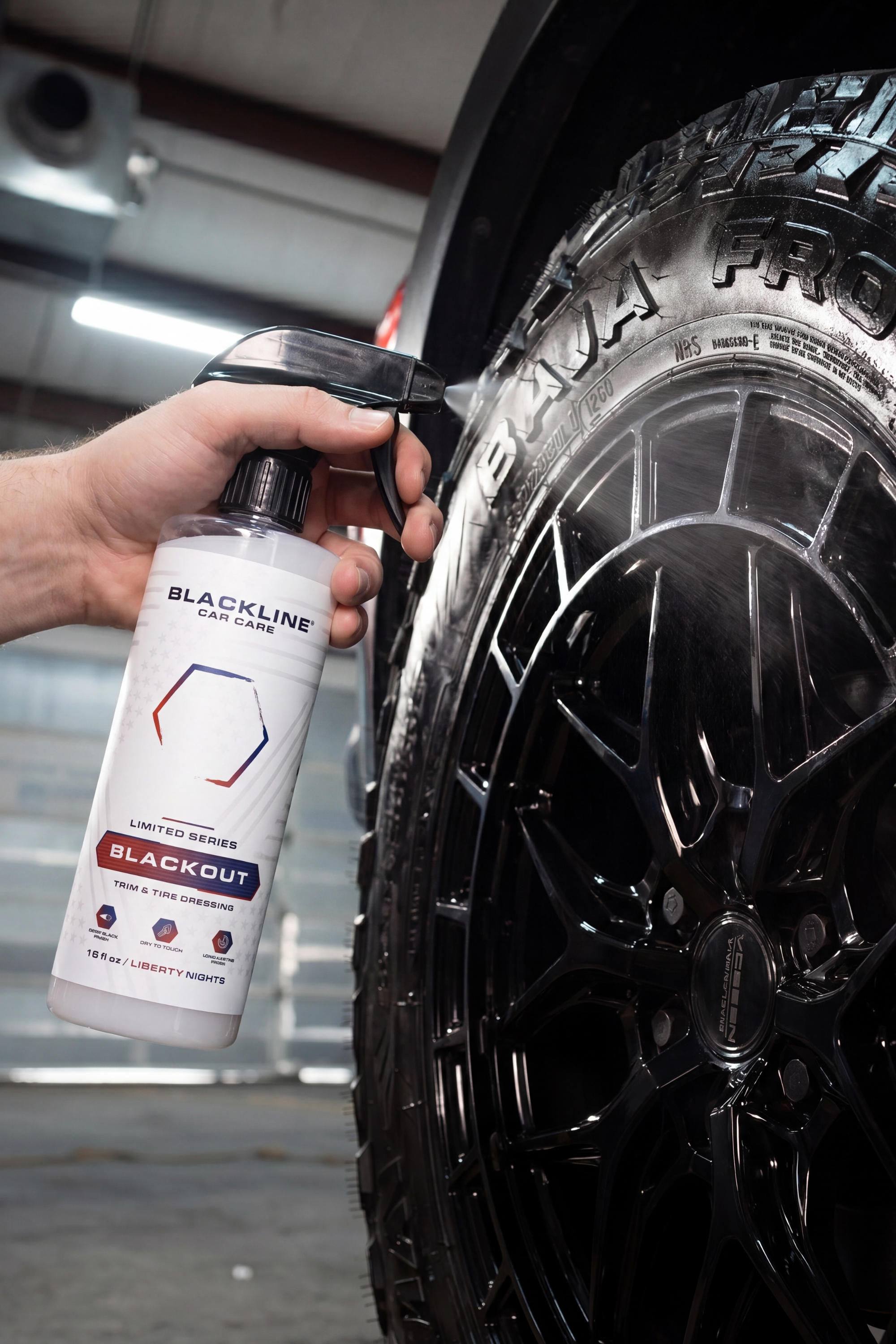 Blackline Blackout Trim & Tire Dressing bottle next to a freshly treated black tire.