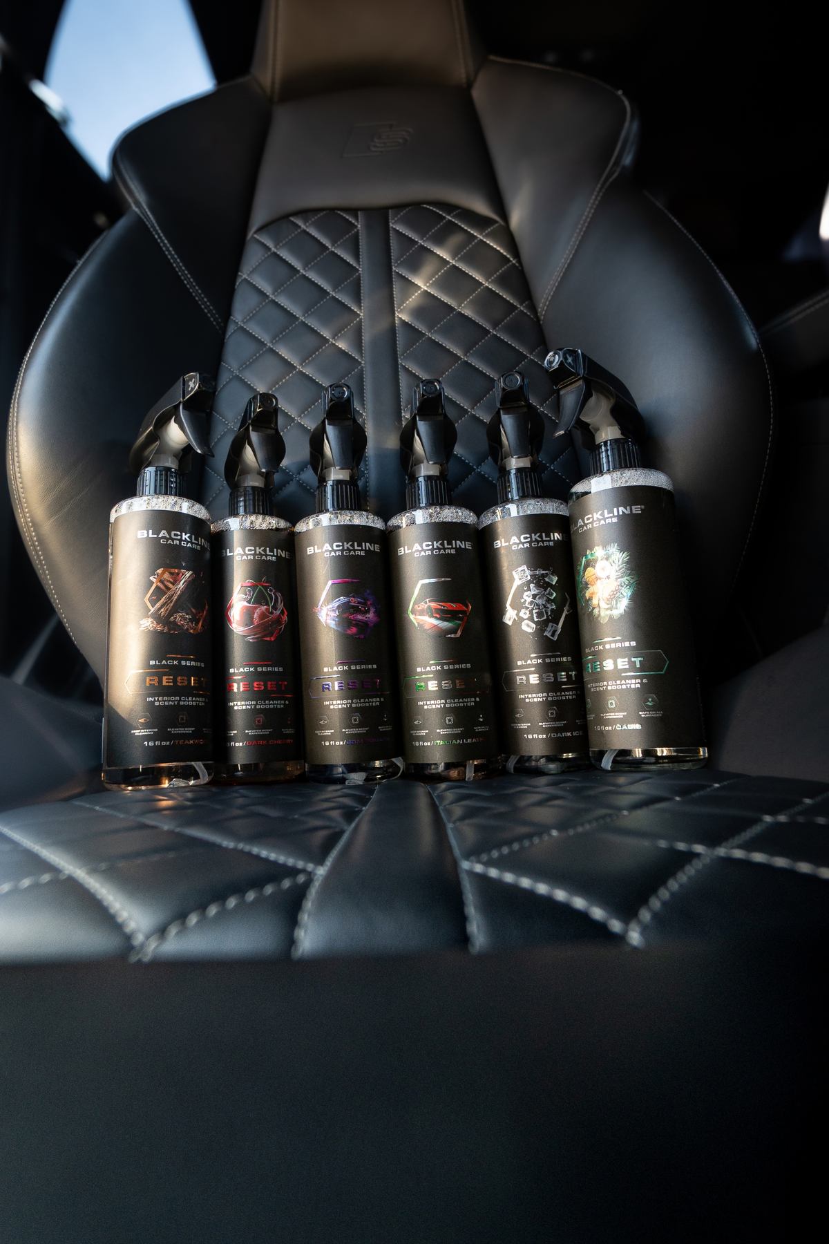 Blackline Reset scent-boosted interior cleaner spray bottle side view on dark background