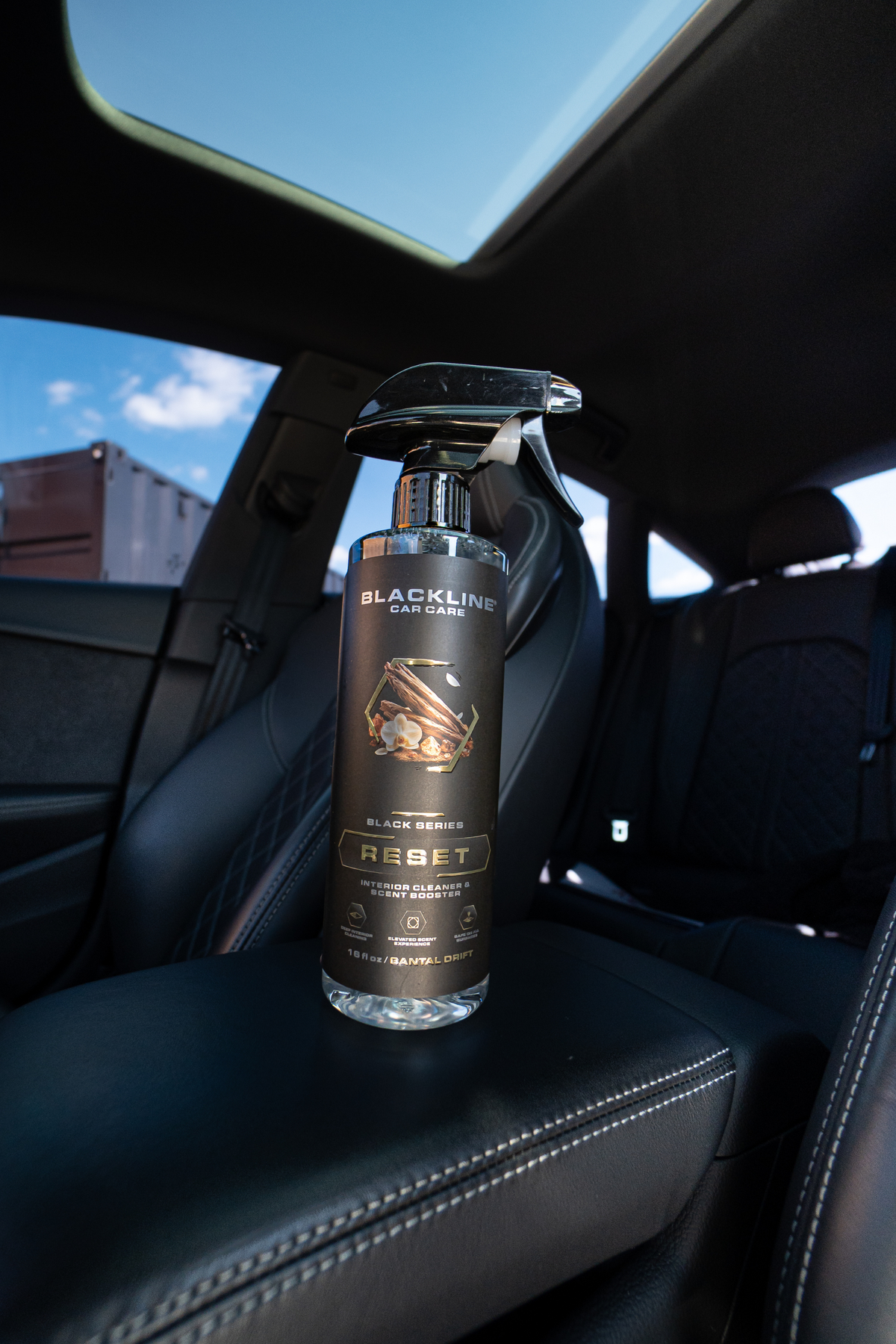 Blackline Reset scented interior cleaner spray bottle angled view on dark background