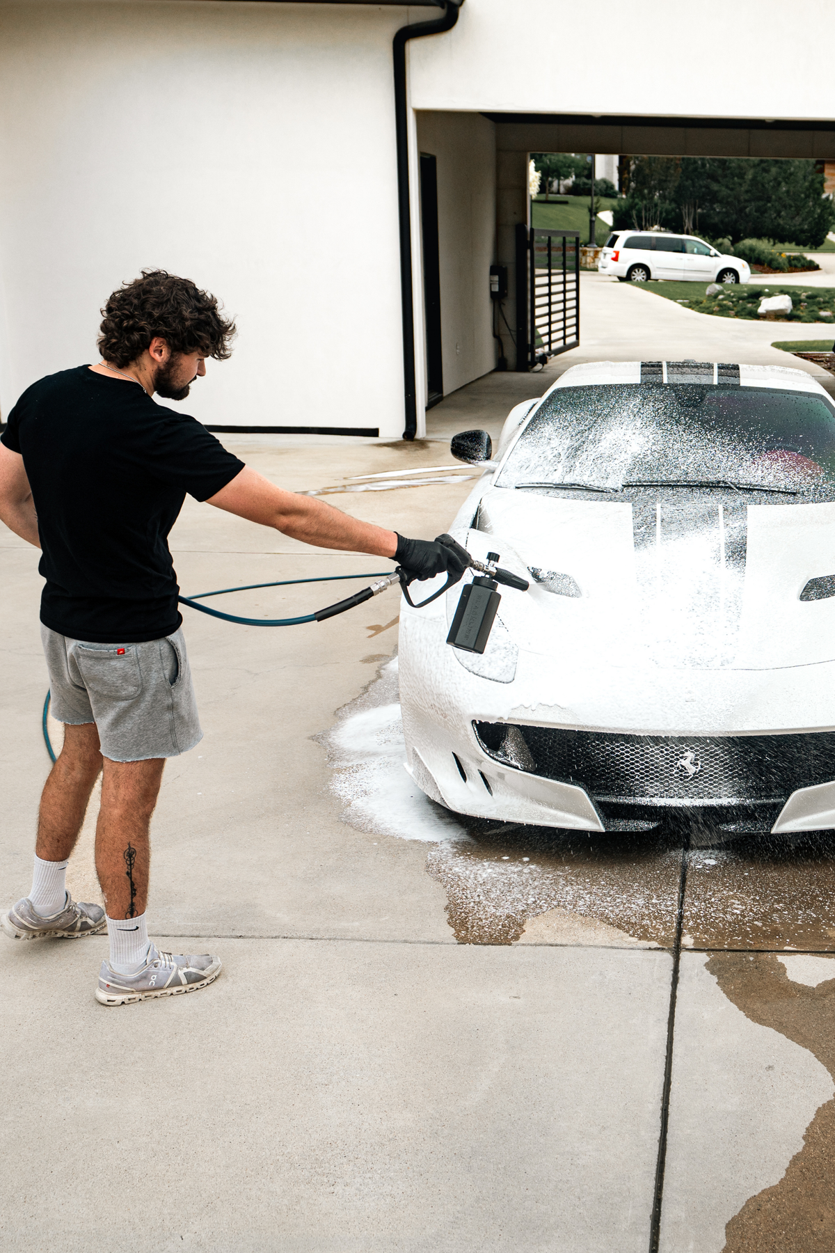 Vehicle panel covered in Blackline Shampoo suds during a wash.