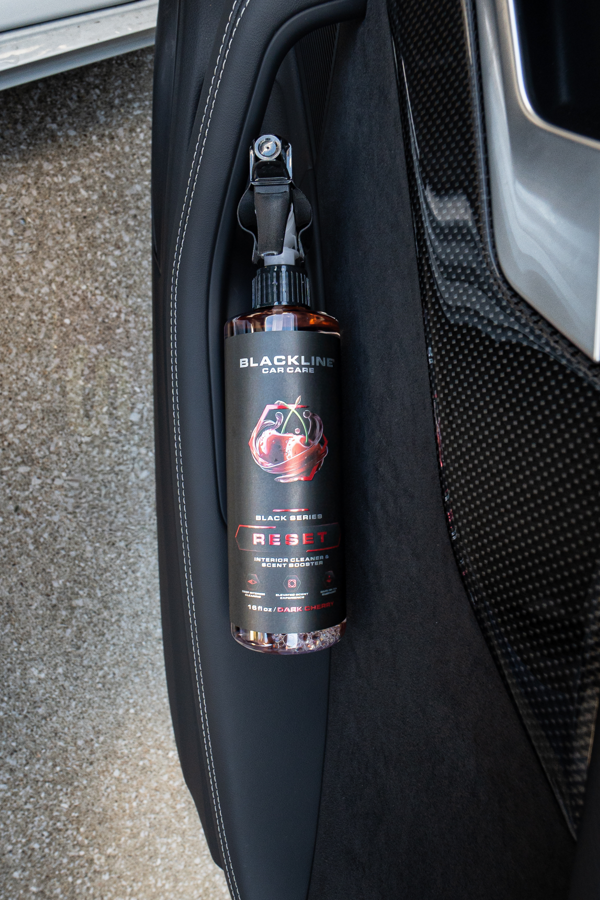 Blackline Reset interior cleaner spray bottle close-up showing nozzle detail on dark background