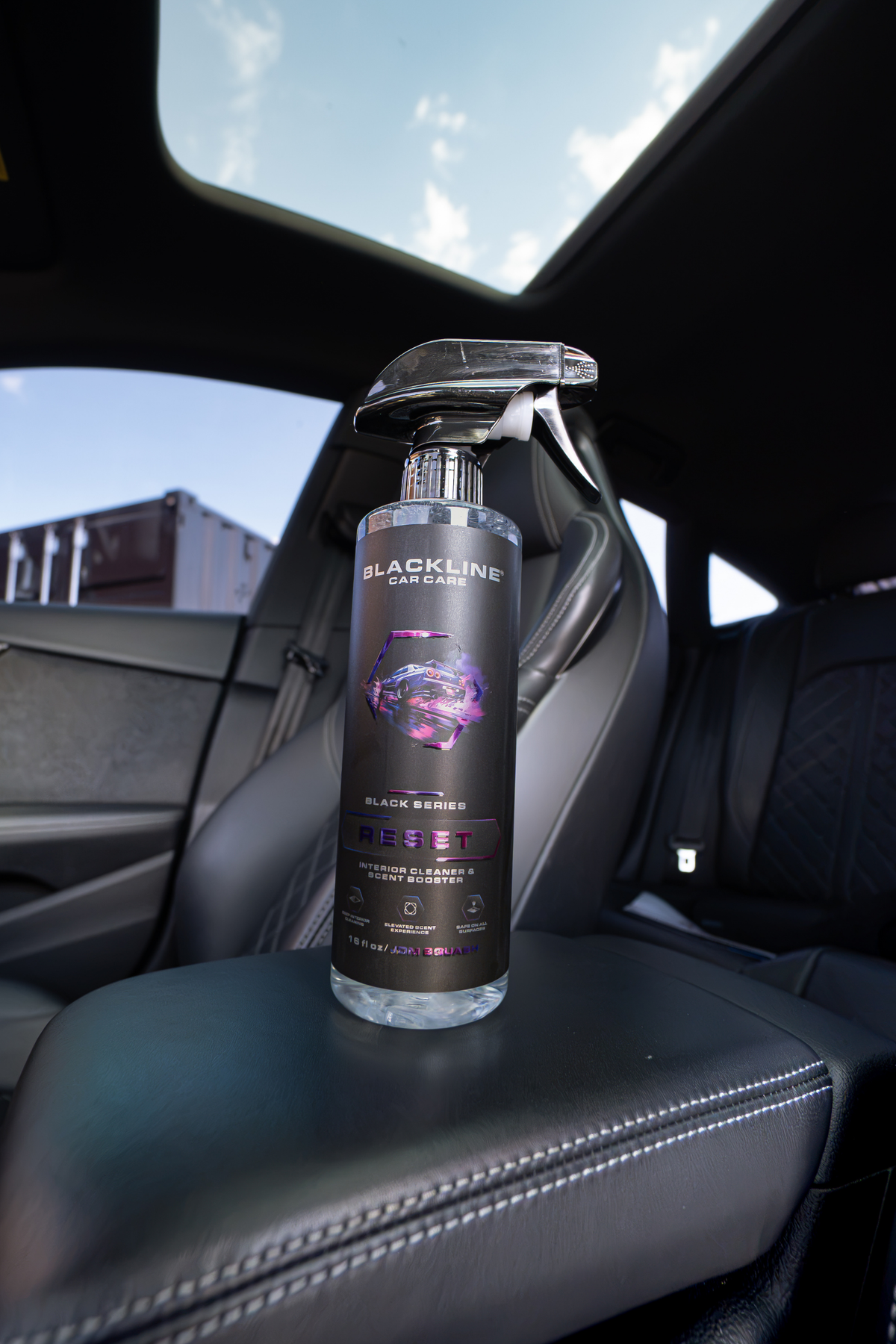 Blackline Reset scented interior cleaner spray bottle overhead angle on dark background