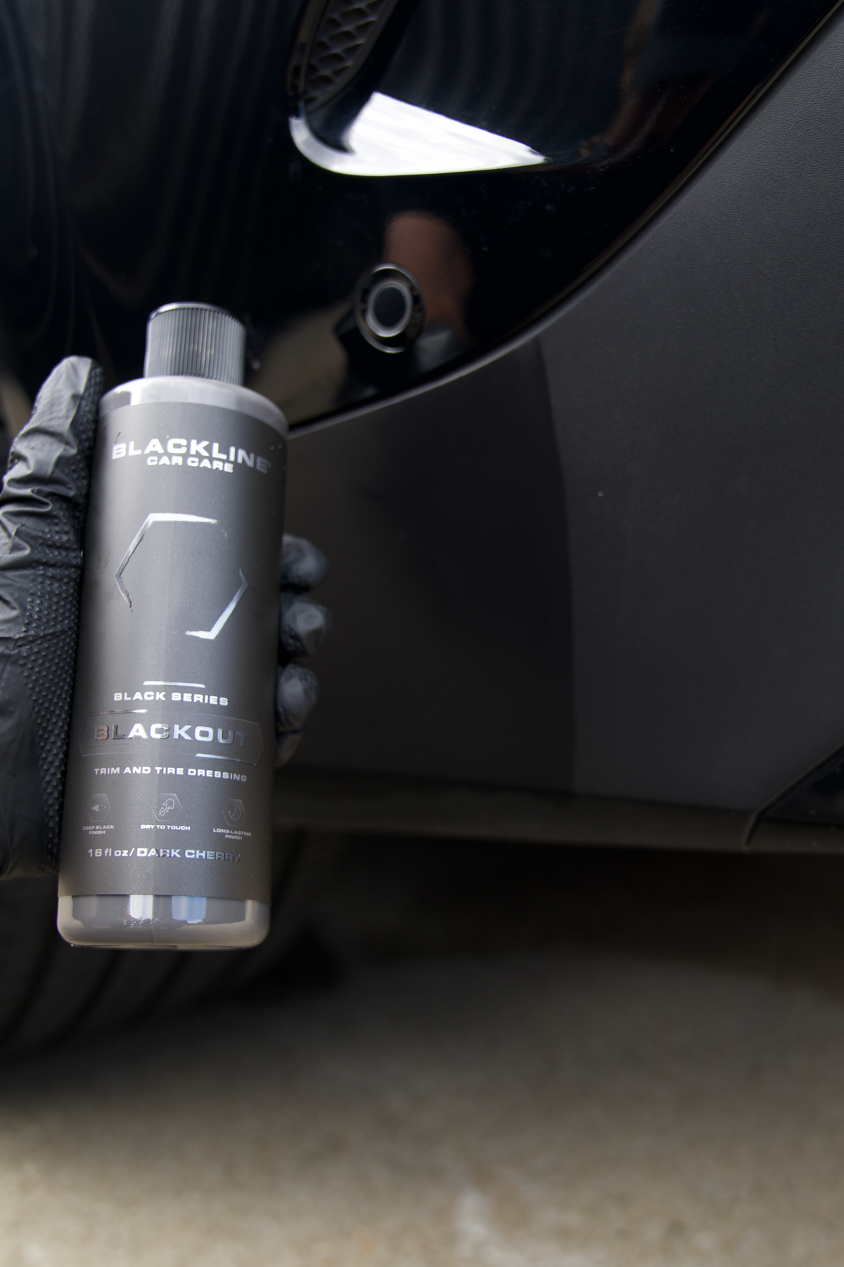 Freshly treated tire showing deep satin-black finish after Blackline Blackout dressing application