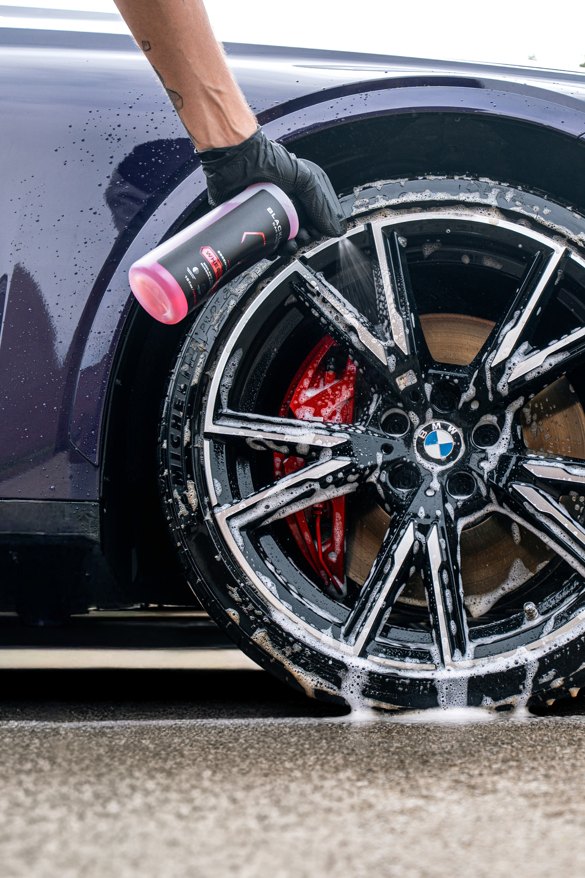 Blackline Essential Series Wheel and Tire cleaner black spray bottle on dark background.