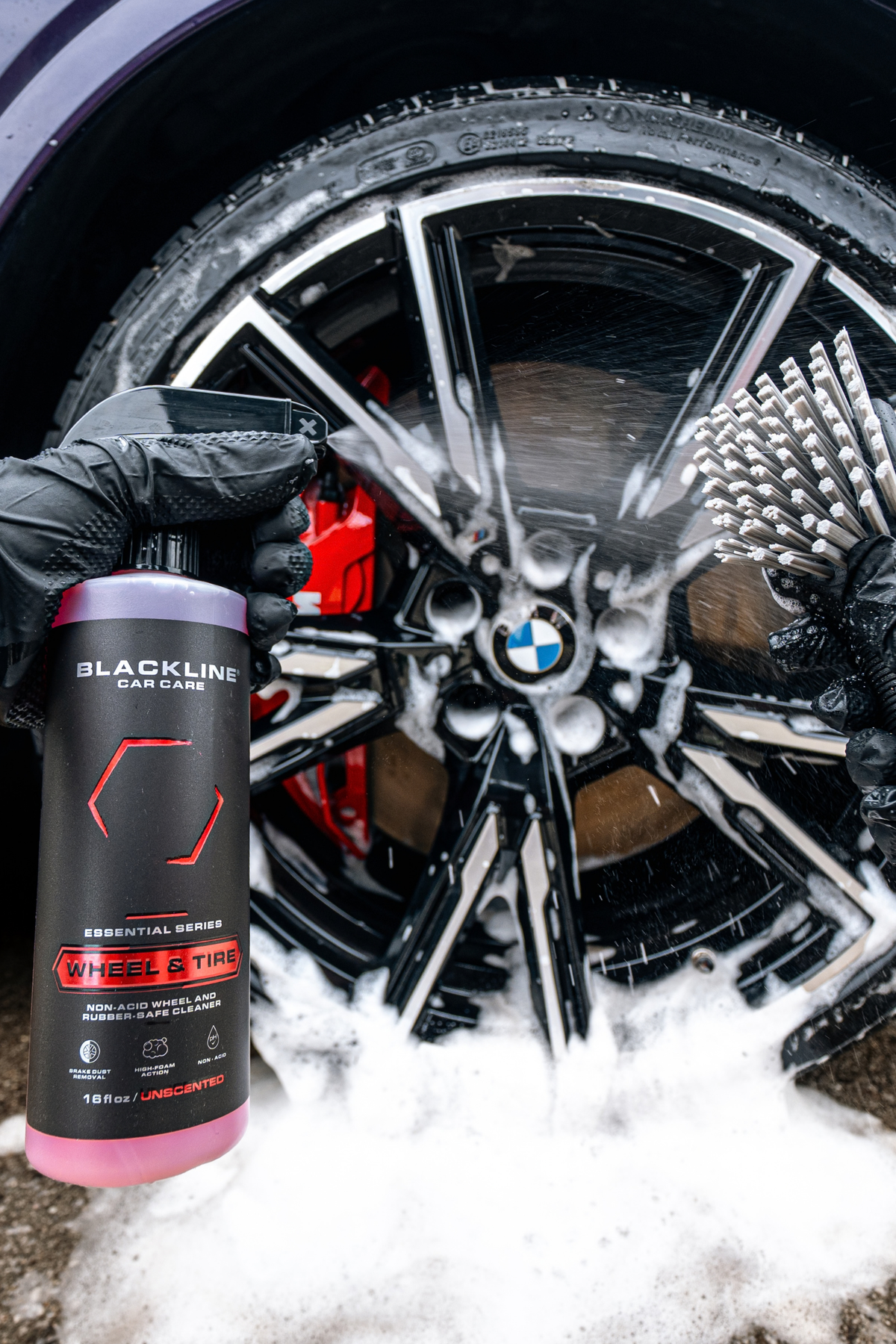 Blackline Wheel and Tire cleaner sprayed onto a dirty alloy wheel during car wash.