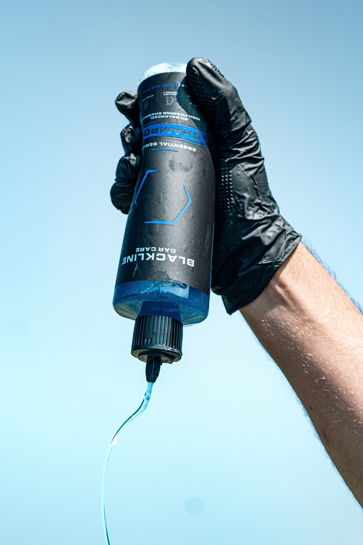 Blackline Shampoo dispensed into a wash bucket producing rich, thick foam lather.