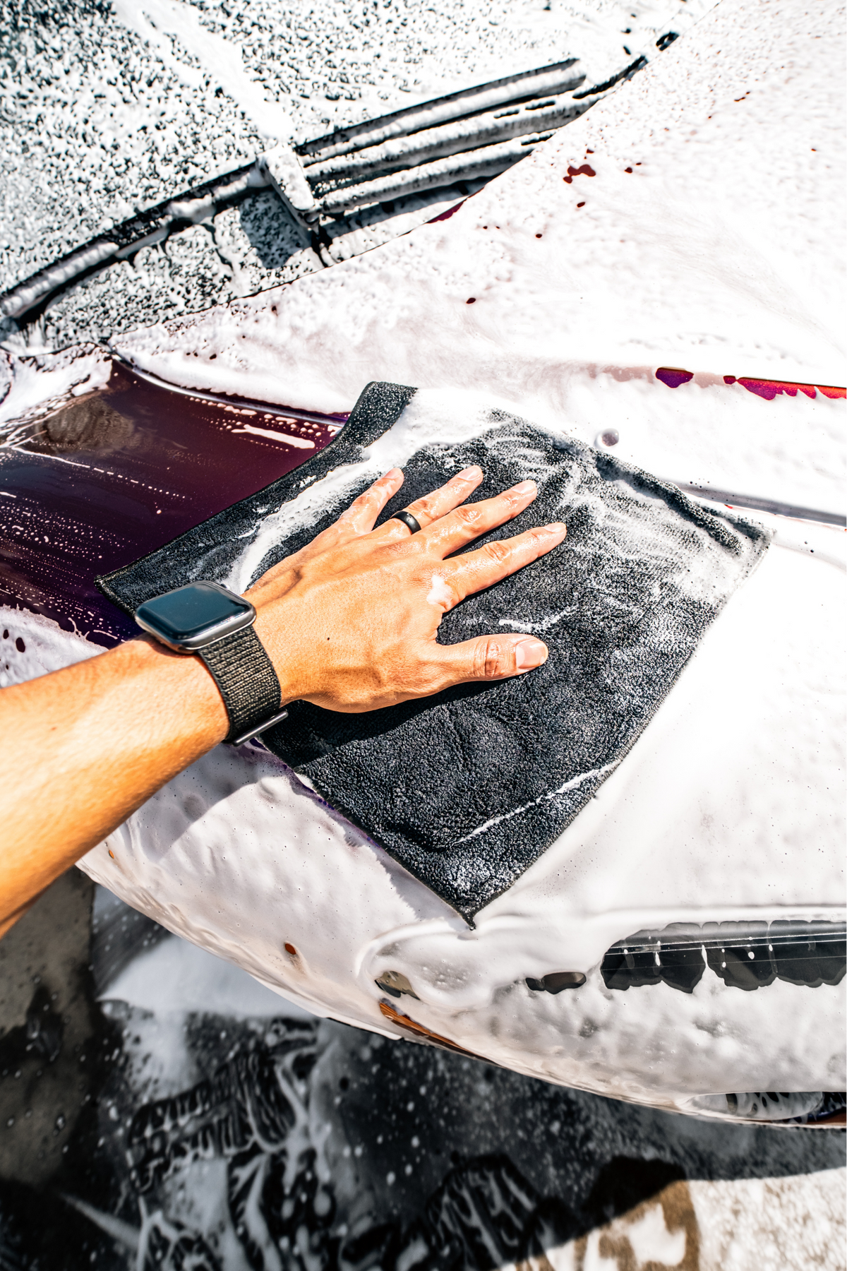 Blackline Synthetic Clay Towel gliding over foamy paint to pull out bonded contamination.