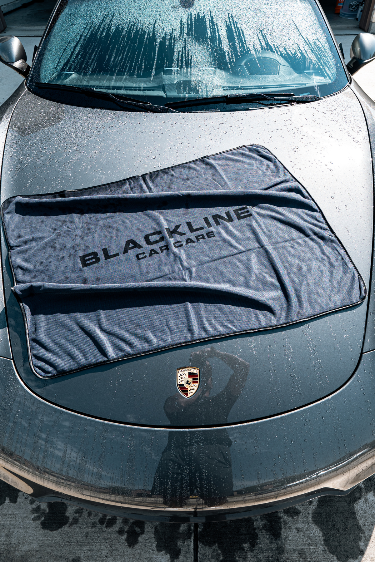 Blackline Slim Twisted-Loop Drying Towel laid across a Porsche hood to dry it.