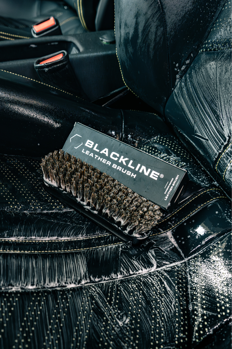 Blackline Leather Brush being used to clean stitched leather.