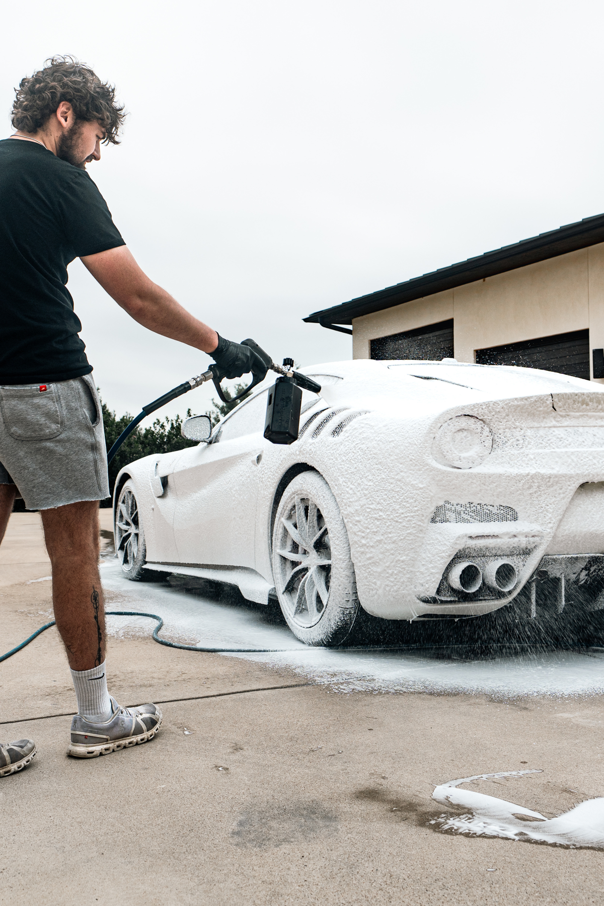 Blackline Foam Cannon Pro pressure washer attachment on dark background