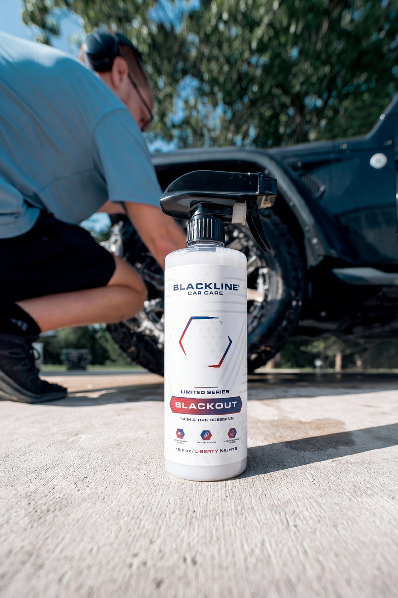 Applying Blackline Blackout dressing to a vehicle tire sidewall with an applicator pad.