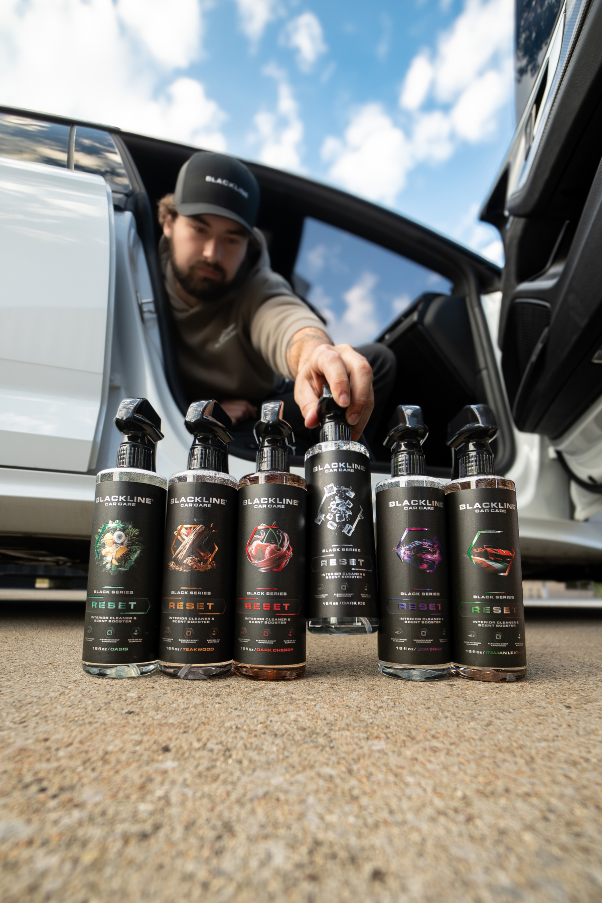 Blackline Reset scent-boosted interior cleaner spray bottle, angled view on dark background