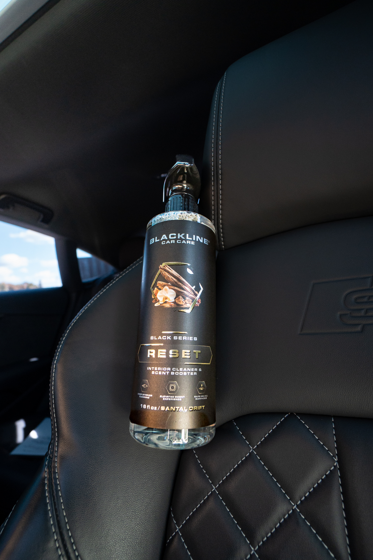 Blackline Reset interior cleaner black spray bottle front view with label on dark background
