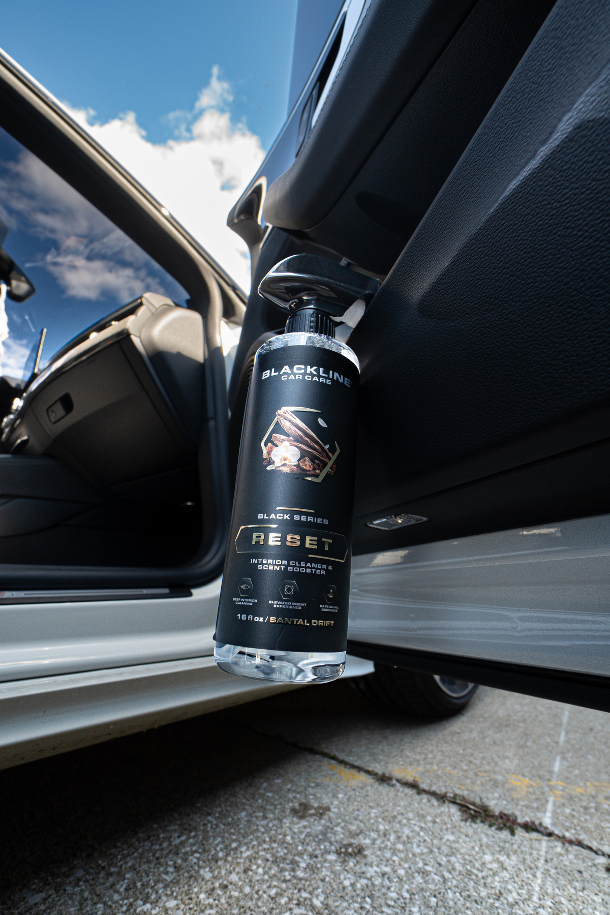 Blackline Reset interior cleaner spray bottle close-up detail shot on dark background