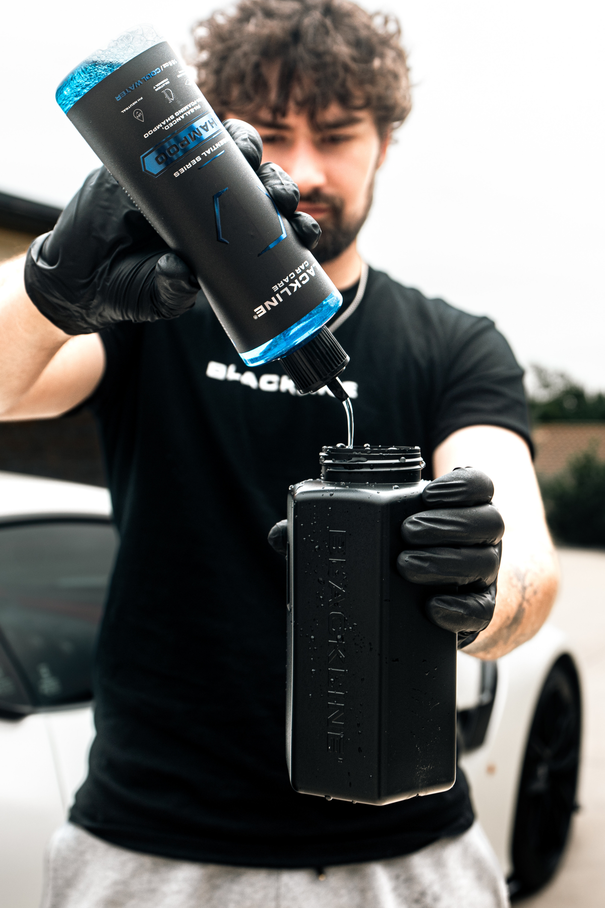 Blackline Shampoo applied with a wash mitt over a vehicle's glossy paint.