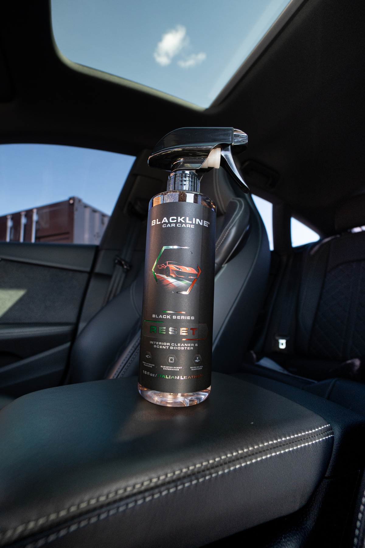Blackline Reset interior cleaner spray bottle on dark background, alternate angle