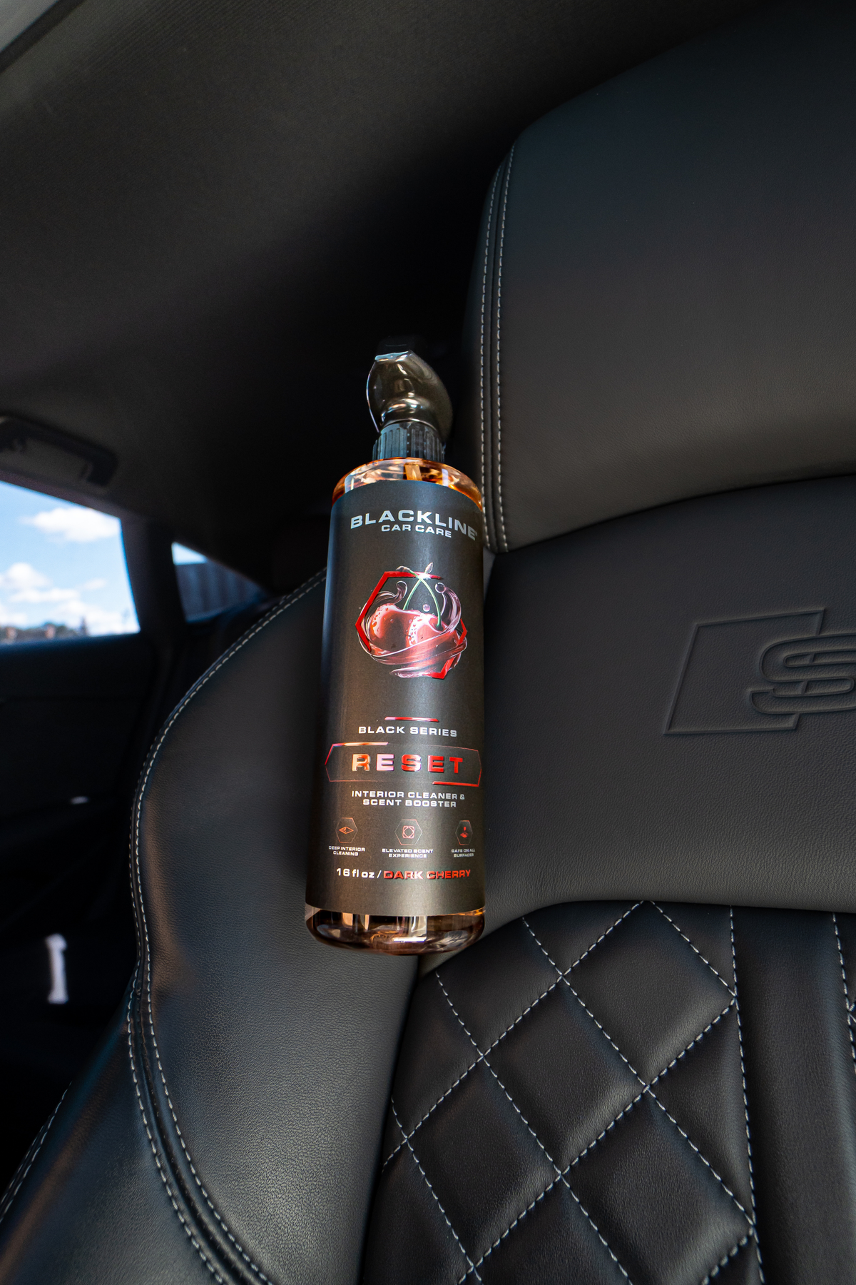 Blackline Reset scented interior cleaner bottle angled view showing product label on dark background