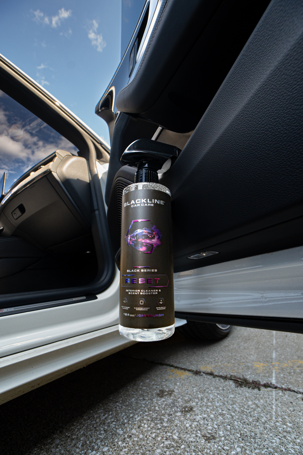 Blackline Reset interior cleaner being wiped in with a microfiber towel on a car interior panel