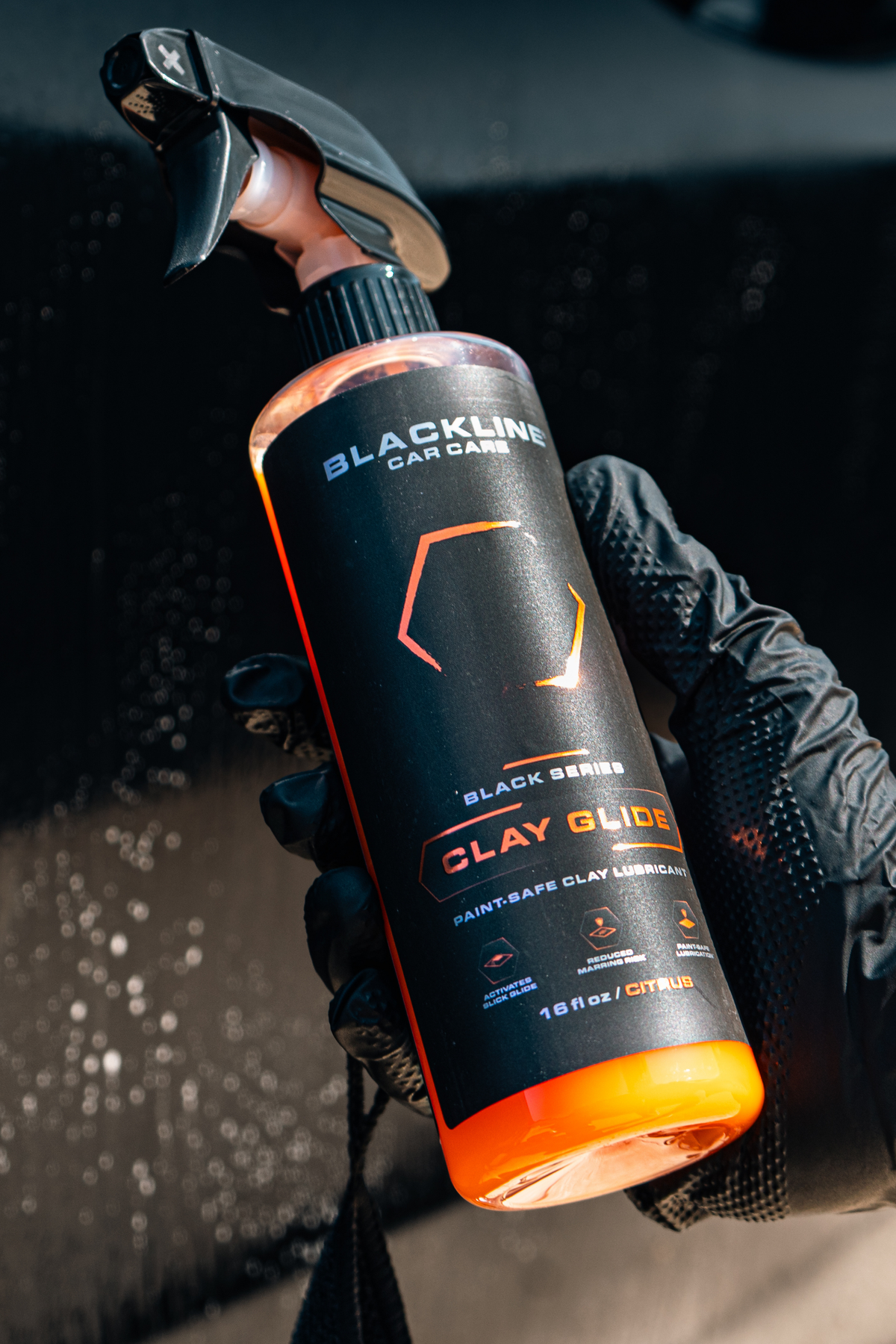 Blackline Clay Glide clay lubricant spray bottle on dark studio background