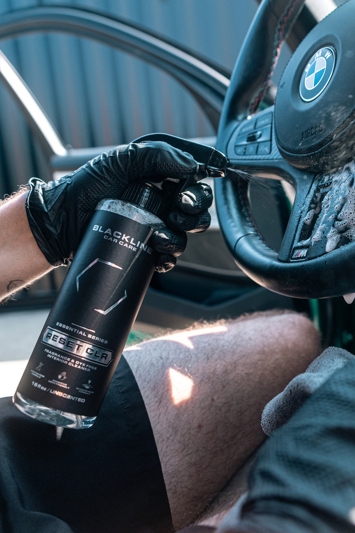 Blackline Reset CLR interior cleaner used on a vehicle dashboard surface.
