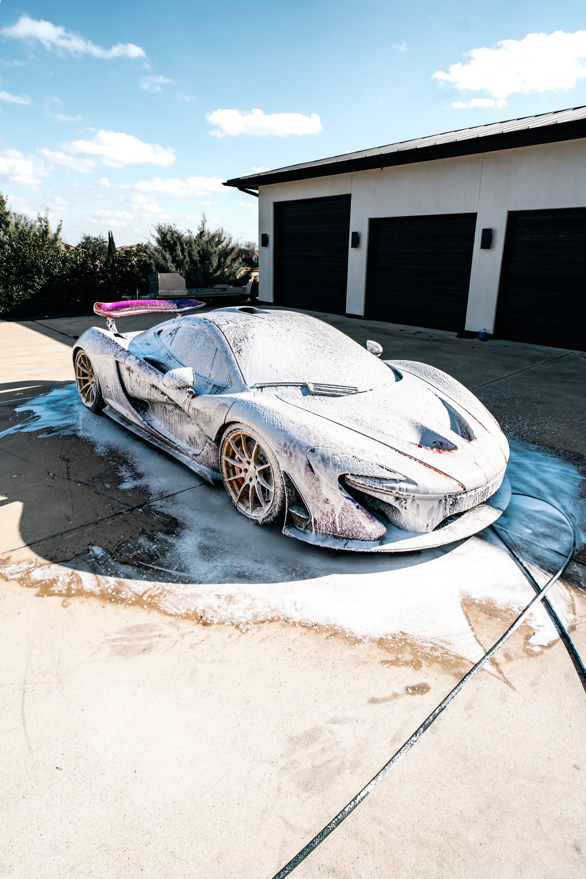 Blackline Ultra Series Foam Cannon lifestyle shot inside a professional car detailing bay.