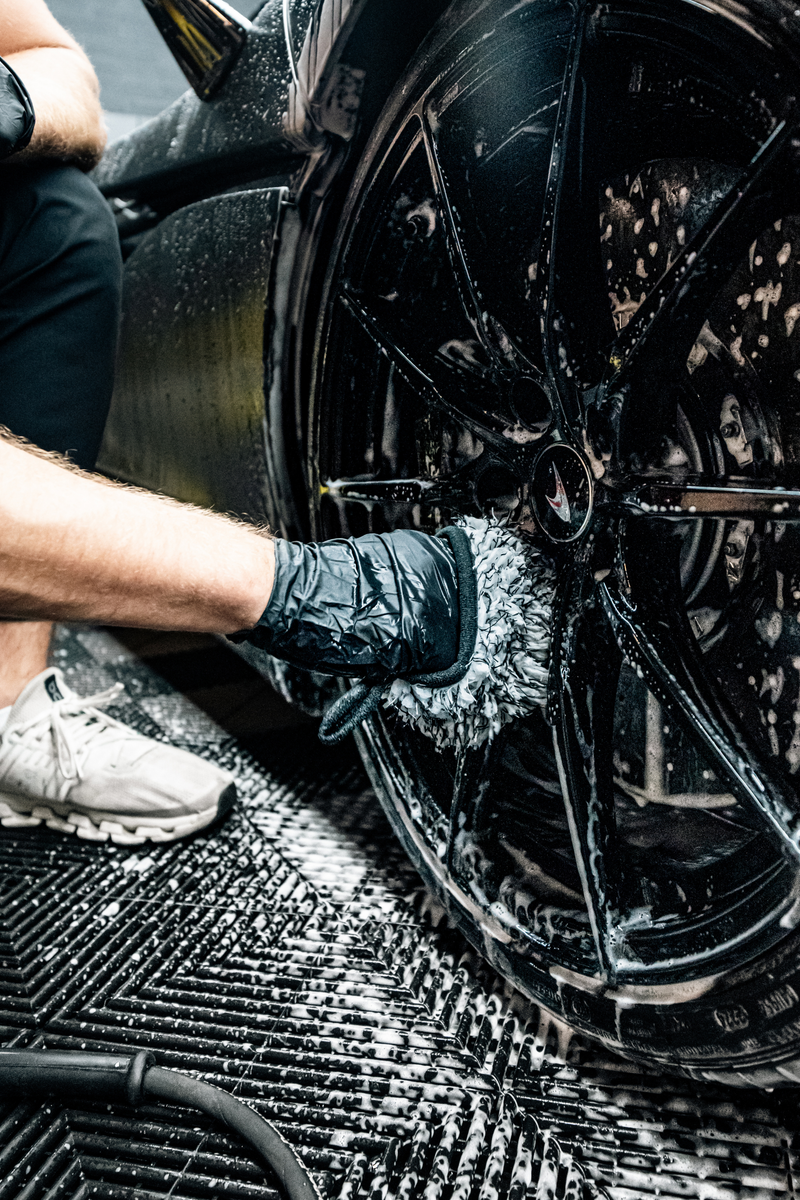 Blackline Wheel Mitt in use cleaning between wheel spokes.