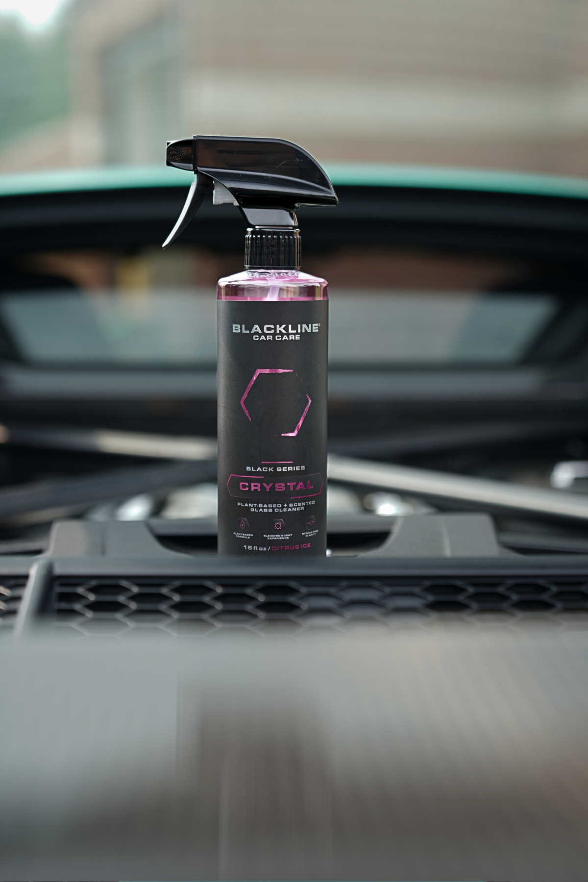Blackline Crystal Glass Cleaner bottle displayed in a polished car engine bay