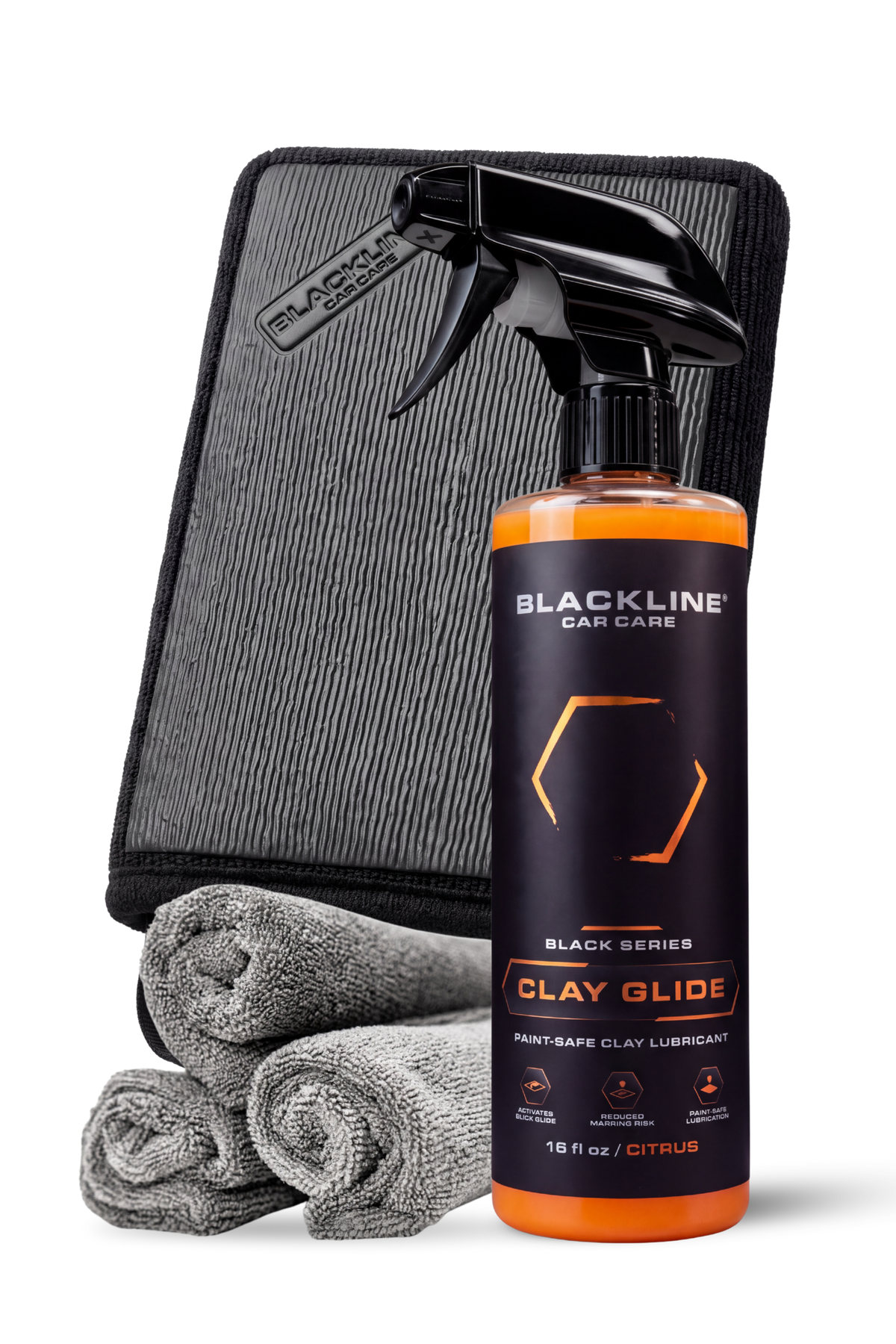 Blackline Clay Mitt complete system with decontamination mitt and lubricant spray on dark background.