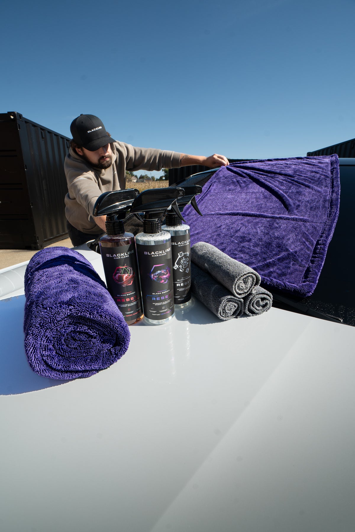 Blackline twisted-loop microfiber drying towel in use wiping down a car panel streak-free