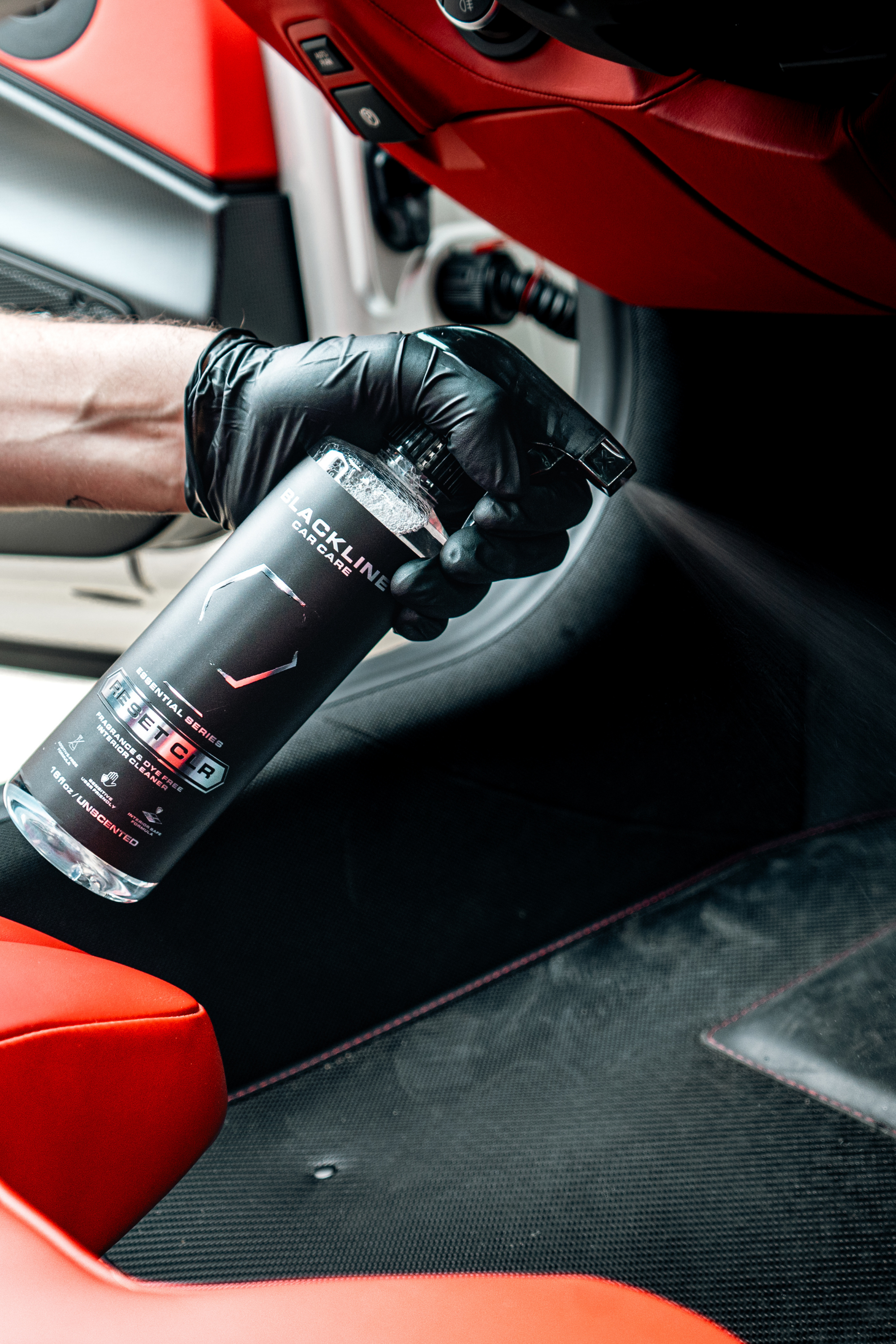 Blackline Reset interior cleaner sprayed onto a car interior panel