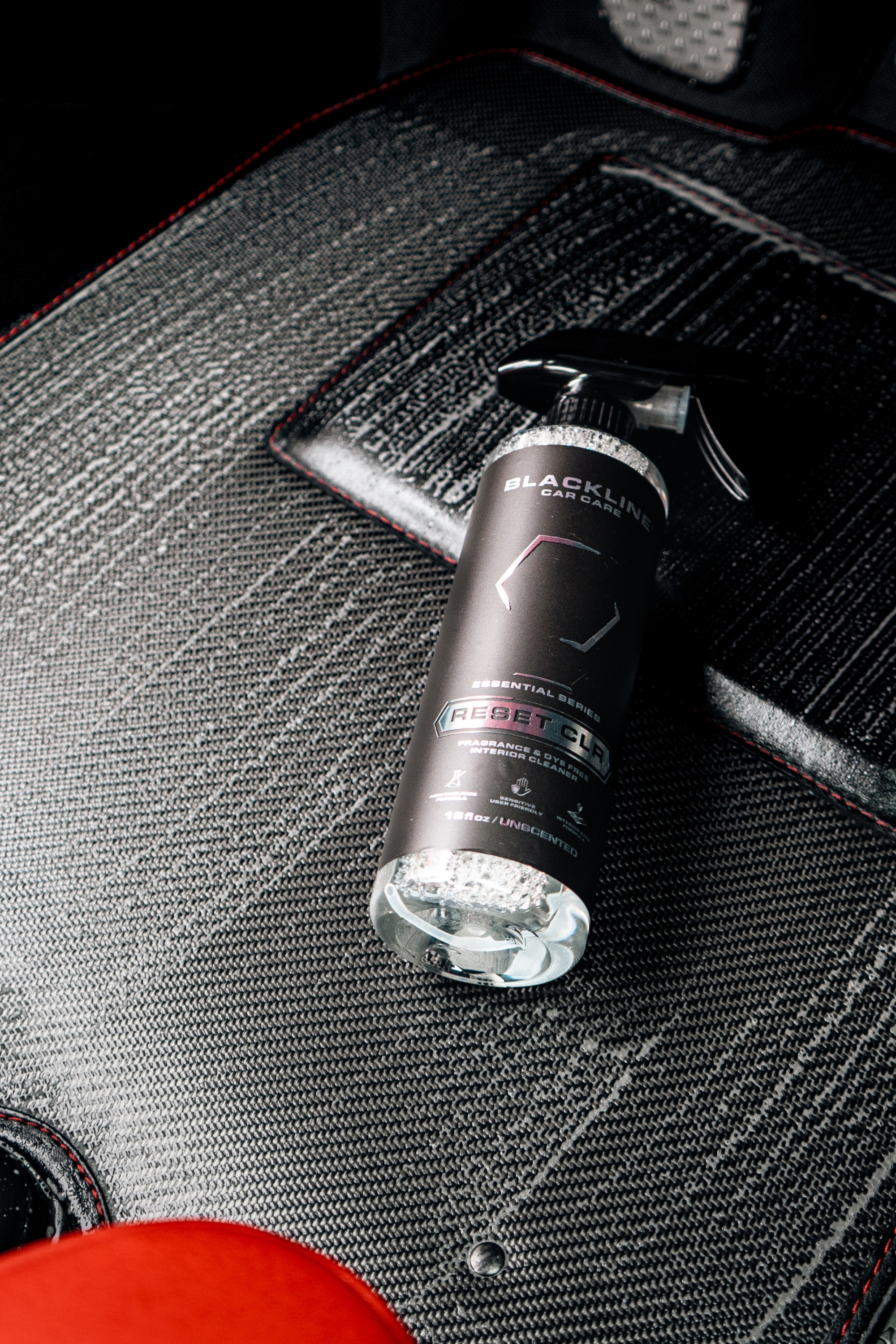 Close-up of Blackline Reset interior cleaner bottle on a textured surface